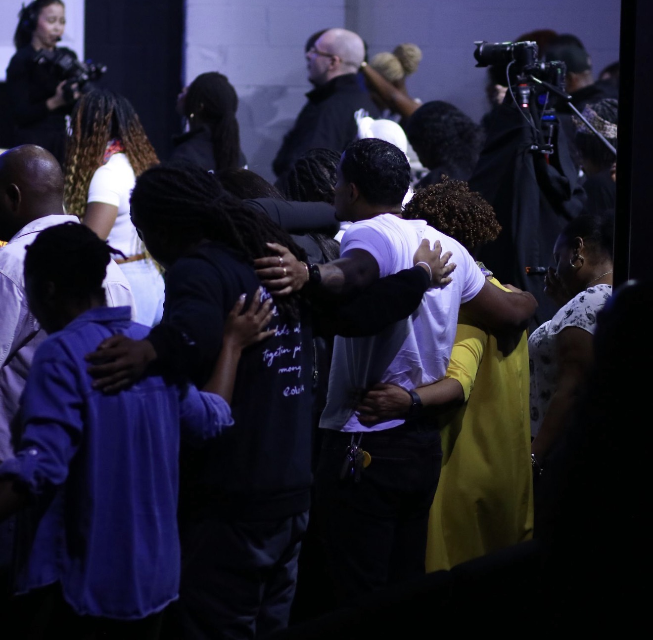 Church members embracing and praying together