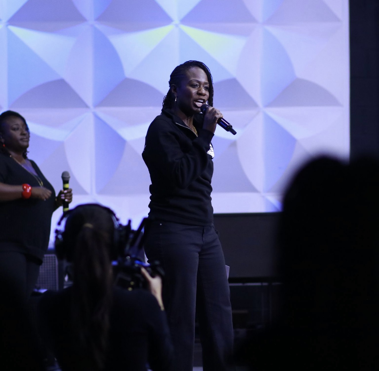 A speaker addressing the congregation from the stage